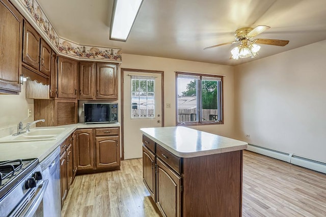 1310 Vinewood Ave, Willow Springs, IL 60480 - kitchen with appliances with stainless steel finishes, light countertops, a center island, light wood finished floors, and a ceiling fan