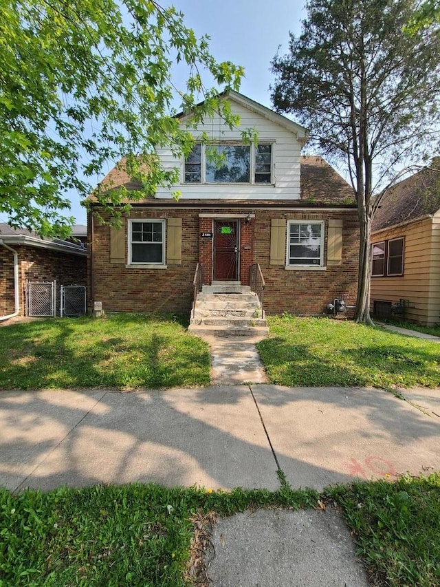 3 E 140th Ct, Riverdale, IL 60827 - bungalow-style home featuring brick siding, a front yard, and a gate