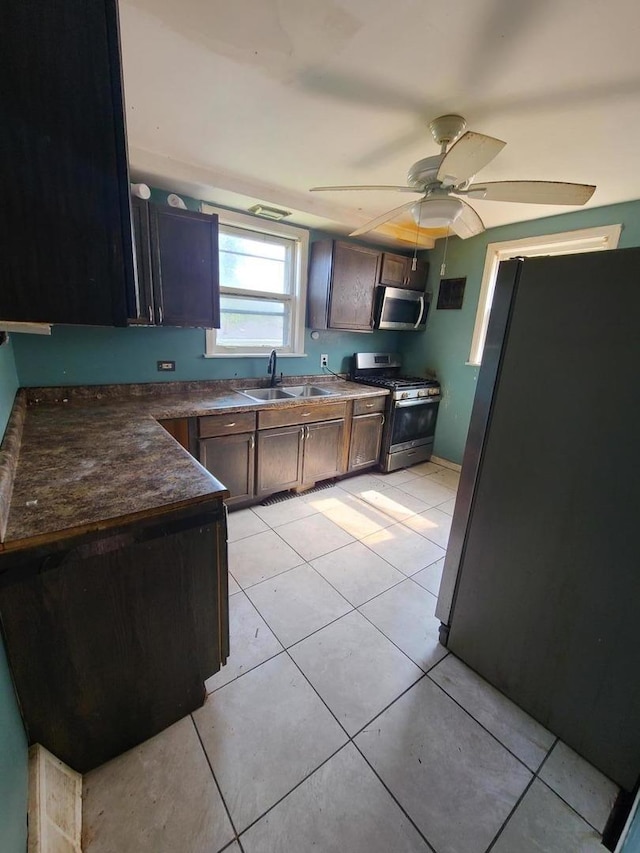 3 E 140th Ct, Riverdale, IL 60827 - kitchen featuring appliances with stainless steel finishes, light tile patterned floors, dark countertops, and ceiling fan