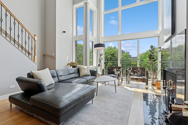 2047 N Leavitt St Unit 2N, Chicago, IL 60647 - living room with wood finished floors, a towering ceiling, and stairs