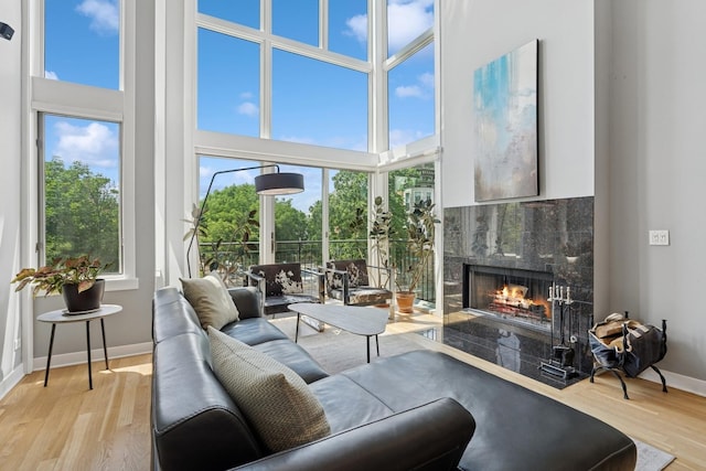 2047 N Leavitt St Unit 2N, Chicago, IL 60647 - living room featuring a high end fireplace, a high ceiling, and wood finished floors
