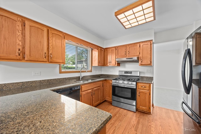 6730 Revere Rd, Downers Grove, IL 60516 - kitchen with stainless steel gas range oven, dishwasher, under cabinet range hood, freestanding refrigerator, and light wood-style floors