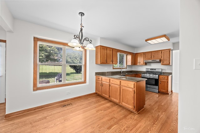 6730 Revere Rd, Downers Grove, IL 60516 - kitchen with stainless steel gas range oven, a chandelier, light wood finished floors, and healthy amount of natural light