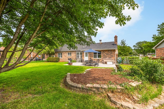 6730 Revere Rd, Downers Grove, IL 60516 - rear view of property featuring a patio area, a chimney, brick siding, and a fenced backyard