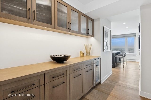 132 E Delaware Pl Unit 5101, Chicago, IL 60611 - bar area featuring beverage cooler, light wood finished floors, and recessed lighting