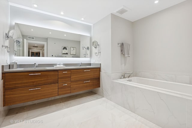 132 E Delaware Pl Unit 5101, Chicago, IL 60611 - full bathroom featuring double vanity, a garden tub, marble finish floors, and recessed lighting