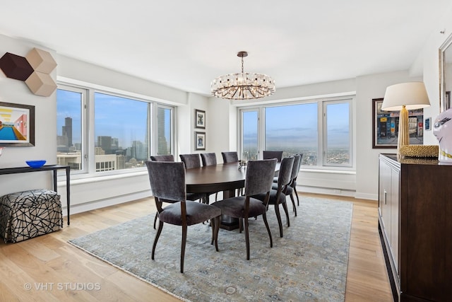 132 E Delaware Pl Unit 5101, Chicago, IL 60611 - dining area featuring a chandelier, light wood finished floors, and a view of skyline
