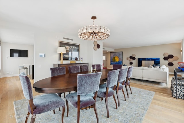 132 E Delaware Pl Unit 5101, Chicago, IL 60611 - dining space featuring light wood finished floors, a chandelier, and recessed lighting