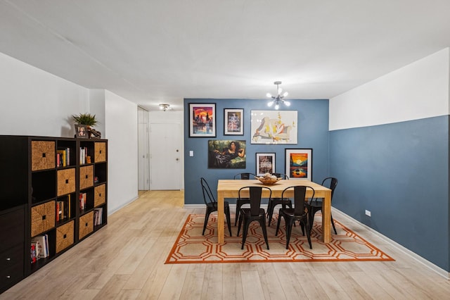 1516 Hinman Ave Unit 209, Evanston, IL 60201 - dining space featuring a chandelier and light wood-style flooring