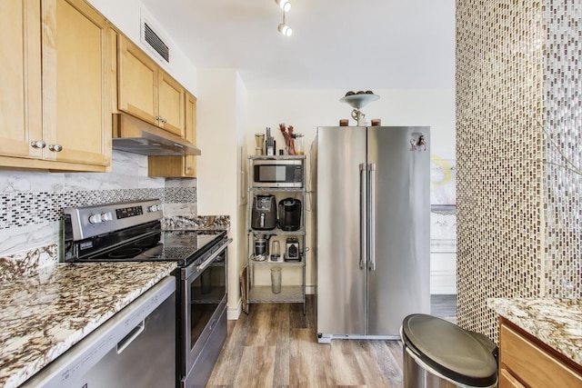 601 E 32nd St Unit 907, Chicago, IL 60616 - kitchen with appliances with stainless steel finishes, under cabinet range hood, light wood-type flooring, and light stone counters