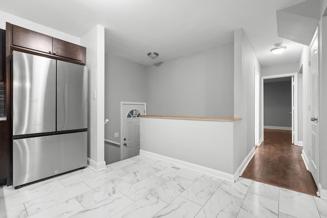 15607 Rose Dr, South Holland, IL 60473 - kitchen featuring freestanding refrigerator, light marble finish flooring, and dark brown cabinetry