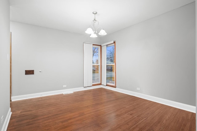 15607 Rose Dr, South Holland, IL 60473 - empty room featuring a chandelier and dark wood-style floors