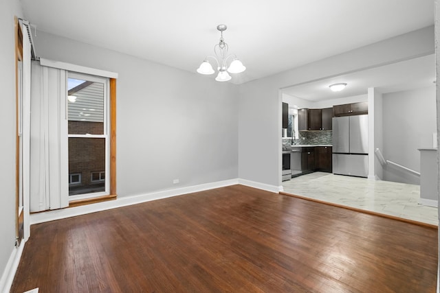 15607 Rose Dr, South Holland, IL 60473 - unfurnished living room featuring a chandelier and light wood-type flooring