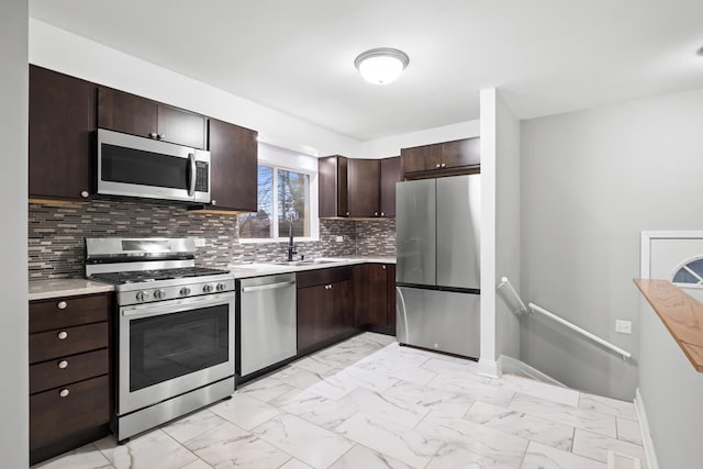 15607 Rose Dr, South Holland, IL 60473 - kitchen featuring stainless steel appliances, light countertops, and light marble finish flooring