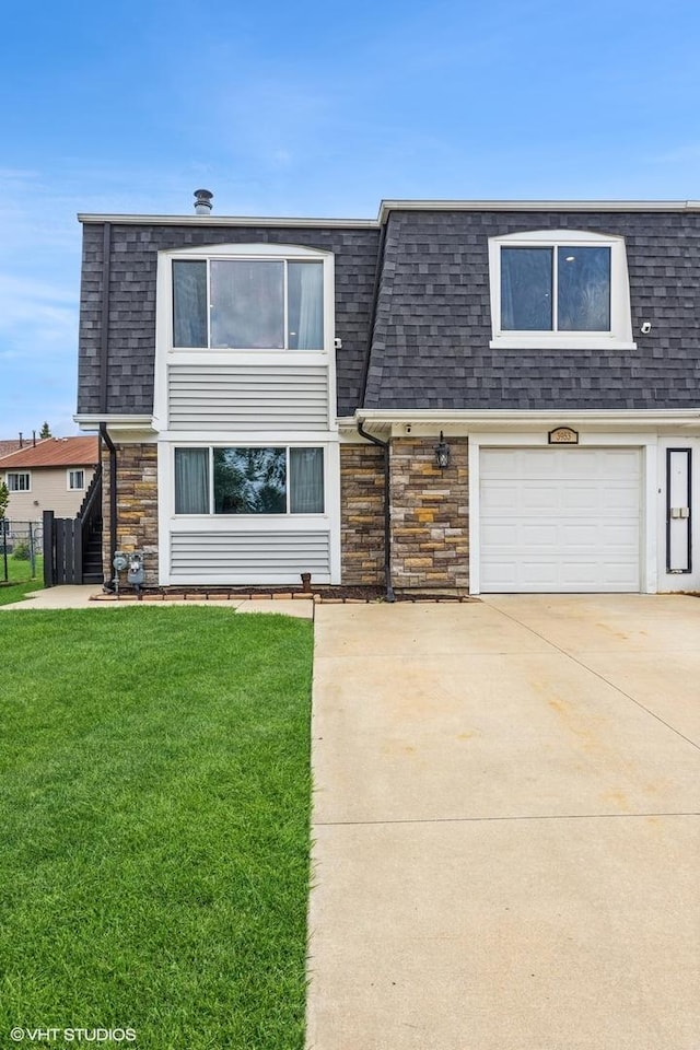 3953 Sandpiper Dr Unit 3953, Hanover Park, IL 60133 - view of front of home with a shingled roof, stone siding, an attached garage, and mansard roof
