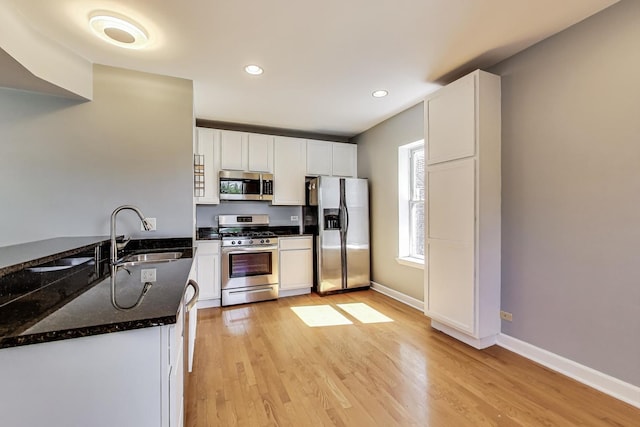 2618 W Rosemont Ave Unit 3, Chicago, IL 60659 - kitchen featuring stainless steel appliances, light wood-style flooring, dark stone counters, white cabinets, and recessed lighting