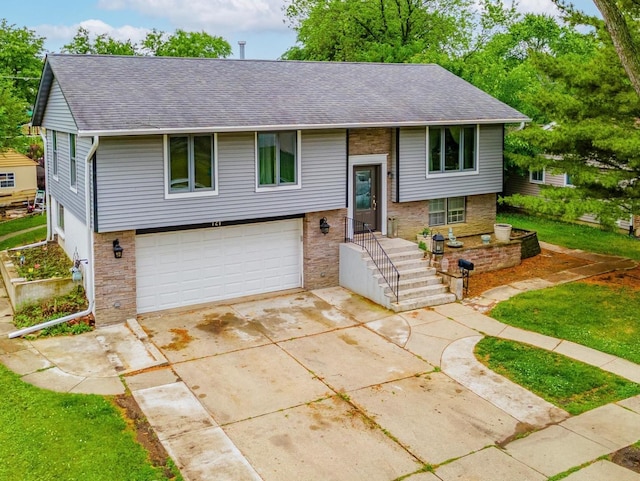 721 Lacy Ave, Streamwood, IL 60107 - raised ranch with a garage, roof with shingles, driveway, and brick siding