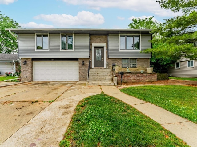 721 Lacy Ave, Streamwood, IL 60107 - bi-level home featuring an attached garage, driveway, and a front lawn