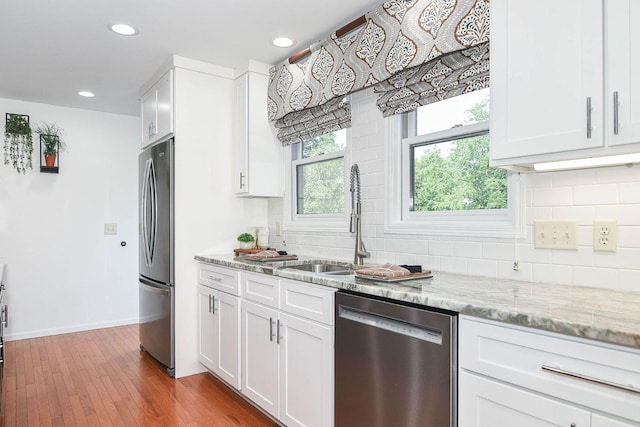3 Laurel Ct, Galena, IL 61036 - kitchen featuring stainless steel appliances, backsplash, recessed lighting, white cabinetry, and light stone counters