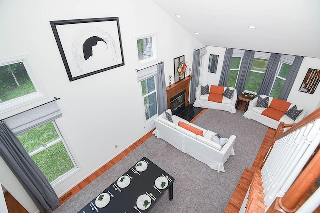 3 Laurel Ct, Galena, IL 61036 - living room featuring healthy amount of natural light, wood finished floors, a fireplace with flush hearth, lofted ceiling, and recessed lighting
