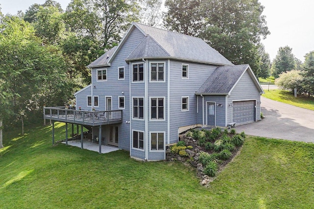 3 Laurel Ct, Galena, IL 61036 - back of house featuring asphalt driveway, a garage, a yard, a wooden deck, and view of wooded area