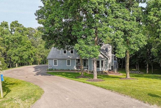 3 Laurel Ct, Galena, IL 61036 - view of front of home with asphalt driveway, a front yard, a chimney, and a shingled roof