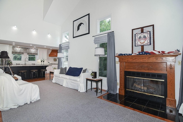 3 Laurel Ct, Galena, IL 61036 - living room featuring a towering ceiling, a fireplace with flush hearth, and carpet