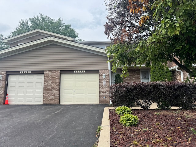 15954 78th Ave, Tinley Park, IL 60477 - view of front of home with driveway, brick siding, and a garage