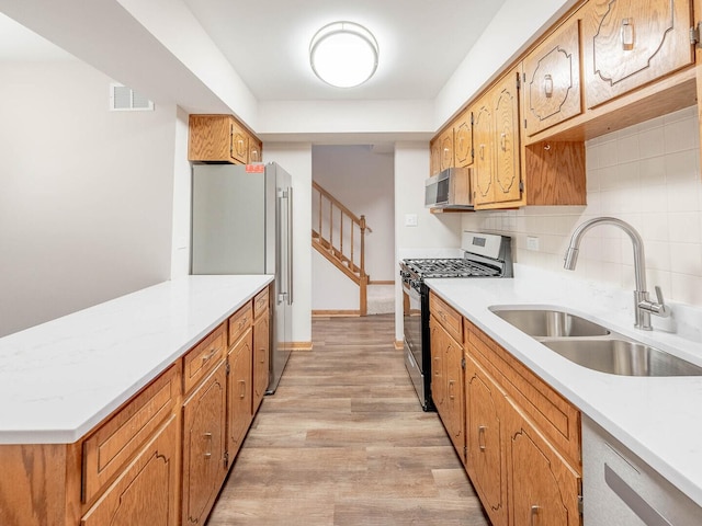 15954 78th Ave, Tinley Park, IL 60477 - kitchen featuring stainless steel appliances, tasteful backsplash, light wood-style floors, light countertops, and a peninsula