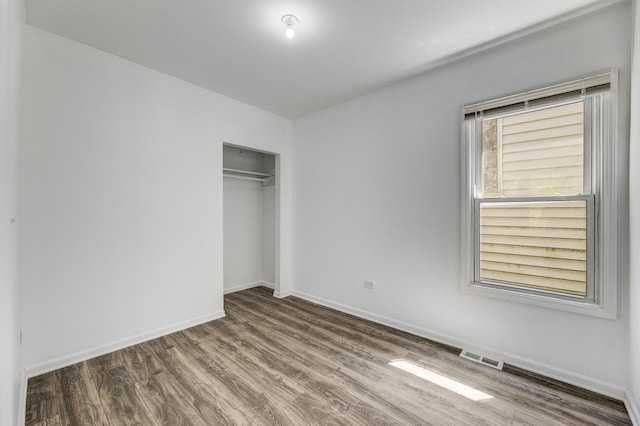 352 W 106th Pl, Chicago, IL 60628 - unfurnished bedroom with wood finished floors and a closet