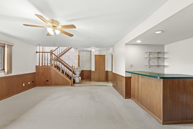 10935 California Ct Unit 185, Orland Park, IL 60467 - bar with a wainscoted wall, wooden walls, ceiling fan, stairway, and light carpet
