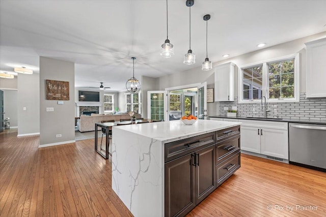 8980 Bardwell Ln, Lakewood, IL 60014 - kitchen with stainless steel dishwasher, backsplash, open floor plan, light wood-type flooring, and recessed lighting