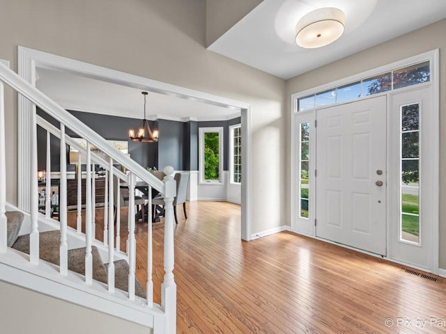 8980 Bardwell Ln, Lakewood, IL 60014 - foyer entrance with stairs, a chandelier, and wood-type flooring
