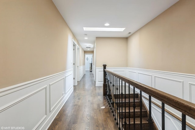 5733 S Neenah Ave, Chicago, IL 60638 - hall with a skylight, a decorative wall, wainscoting, dark wood-style flooring, and an upstairs landing