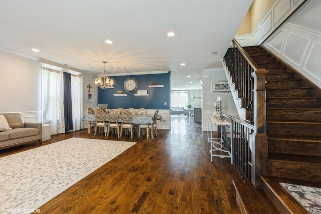 5733 S Neenah Ave, Chicago, IL 60638 - living room featuring a chandelier, a decorative wall, ornamental molding, stairway, and recessed lighting