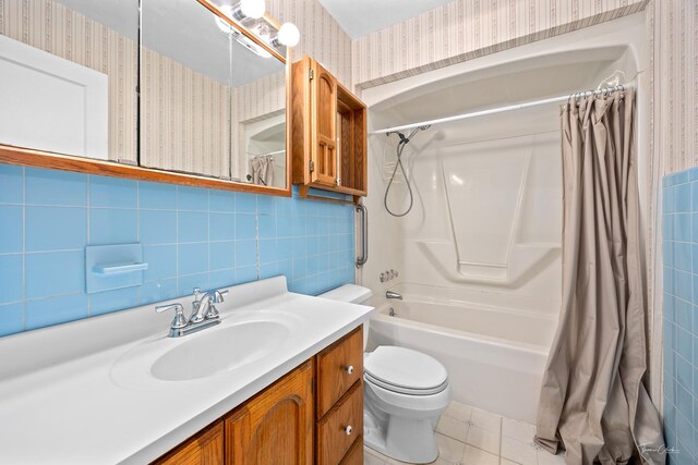 325 Douglas St, Oswego, IL 60543 - full bath featuring wallpapered walls, tile walls, shower / bathtub combination with curtain, vanity, and tile patterned flooring