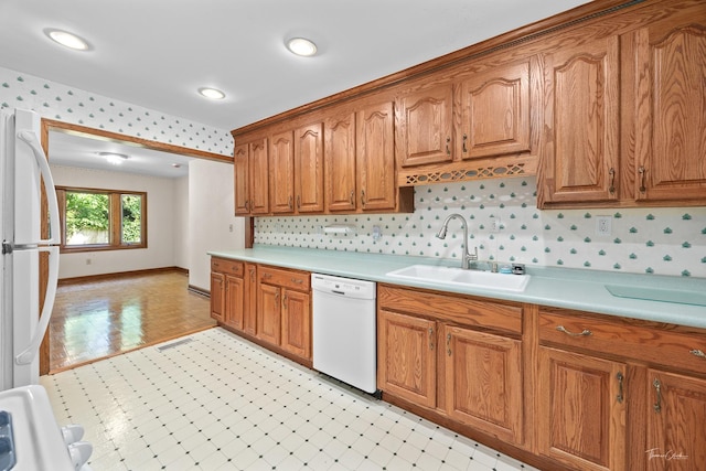 325 Douglas St, Oswego, IL 60543 - kitchen featuring white appliances, light countertops, brown cabinetry, wallpapered walls, and light flooring