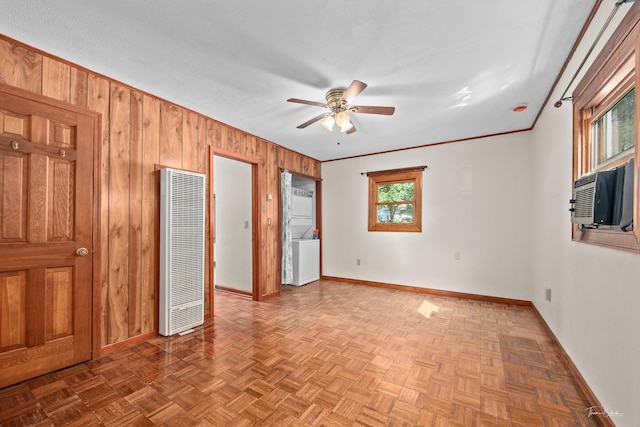 325 Douglas St, Oswego, IL 60543 - unfurnished bedroom with a heating unit, wooden walls, cooling unit, a ceiling fan, and crown molding