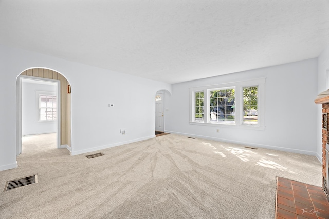 325 Douglas St, Oswego, IL 60543 - unfurnished living room with arched walkways and carpet flooring