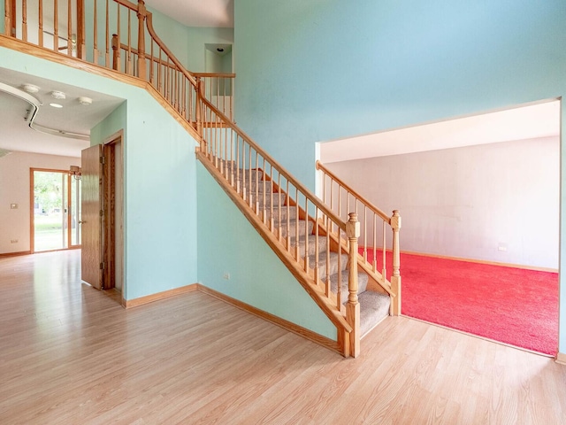 2207 Irvine Ln, Plainfield, IL 60586 - stairs featuring wood finished floors and a towering ceiling