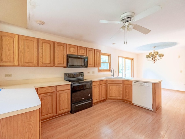 2207 Irvine Ln, Plainfield, IL 60586 - kitchen featuring black appliances, a peninsula, light wood finished floors, a chandelier, and ceiling fan