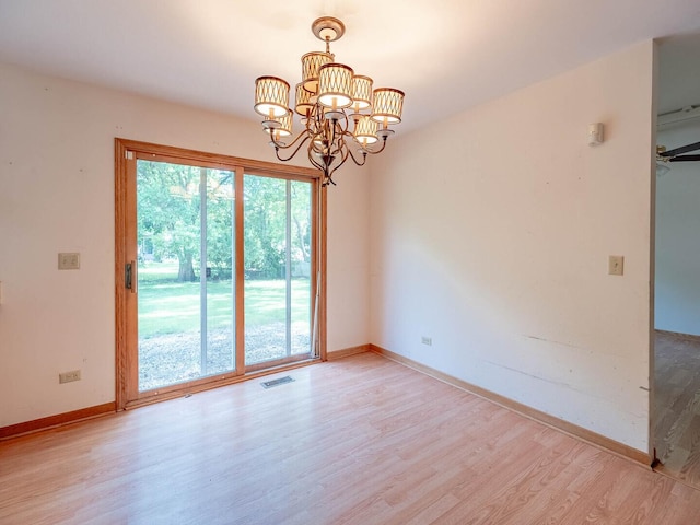 2207 Irvine Ln, Plainfield, IL 60586 - spare room with light wood finished floors and a chandelier