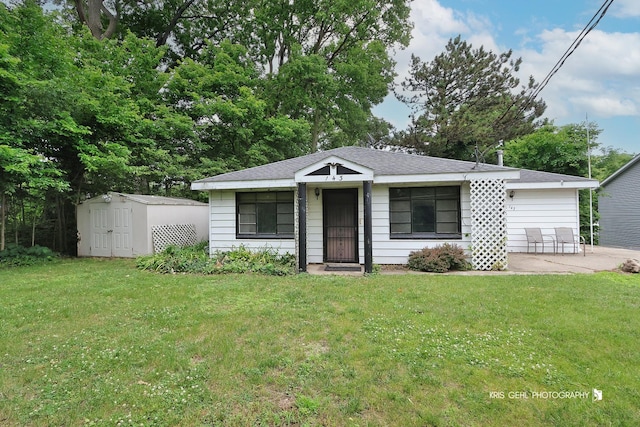 143 Eagle Point Rd, Fox Lake, IL 60020 - bungalow-style house featuring a shed, a front lawn, and a patio area