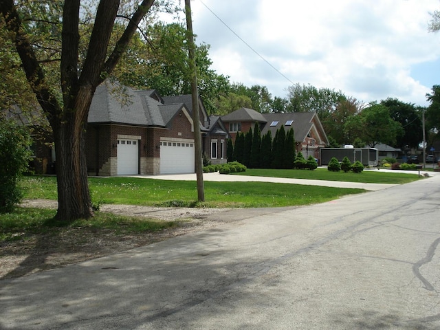 7137 S 87th Ave S, Justice, IL 60458 - view of front of house featuring an attached garage, a front yard, brick siding, and driveway