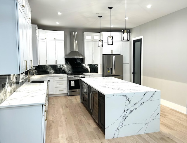 7137 S 87th Ave S, Justice, IL 60458 - kitchen with stainless steel appliances, wall chimney exhaust hood, a center island, recessed lighting, and light wood-type flooring