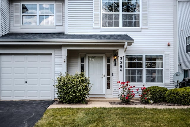 2584 Dickens Dr, Aurora, IL 60503 - entrance to property with a garage, a shingled roof, and driveway