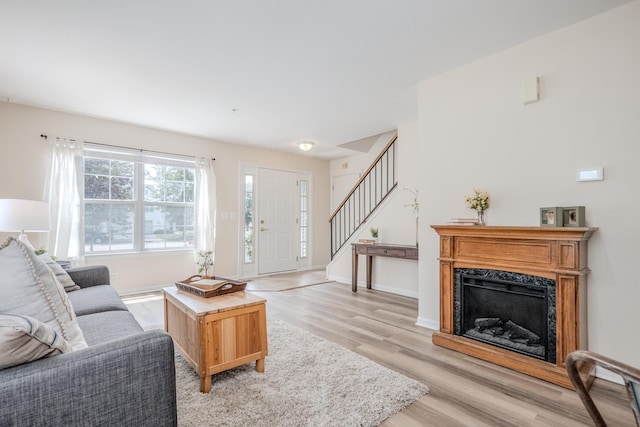 2584 Dickens Dr, Aurora, IL 60503 - living area with stairway, light wood-style floors, and a high end fireplace