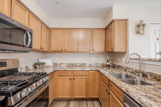 2584 Dickens Dr, Aurora, IL 60503 - kitchen featuring appliances with stainless steel finishes, light wood-style flooring, light stone countertops, and light brown cabinets