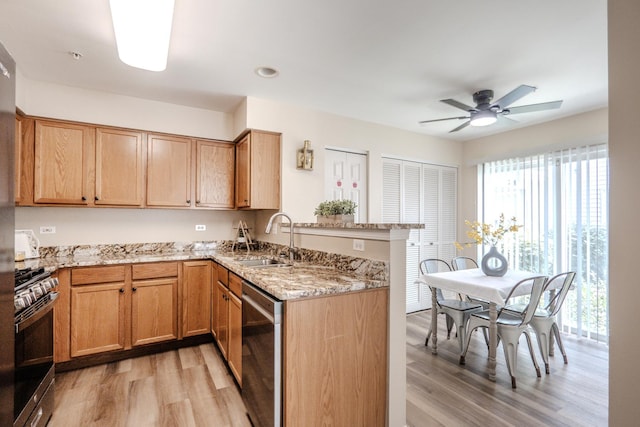 2584 Dickens Dr, Aurora, IL 60503 - kitchen with appliances with stainless steel finishes, light wood-style floors, a peninsula, and light stone countertops