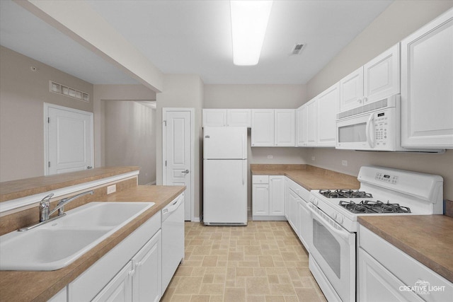 13611 Hemlock Rd, Huntley, IL 60142 - kitchen featuring white appliances, white cabinets, brick patterned floors, and light countertops